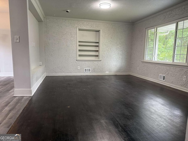 5460 Huron Dr, Morrow, GA 30260 - unfurnished room featuring crown molding, dark wood-style flooring, baseboards, a textured ceiling, and a textured wall