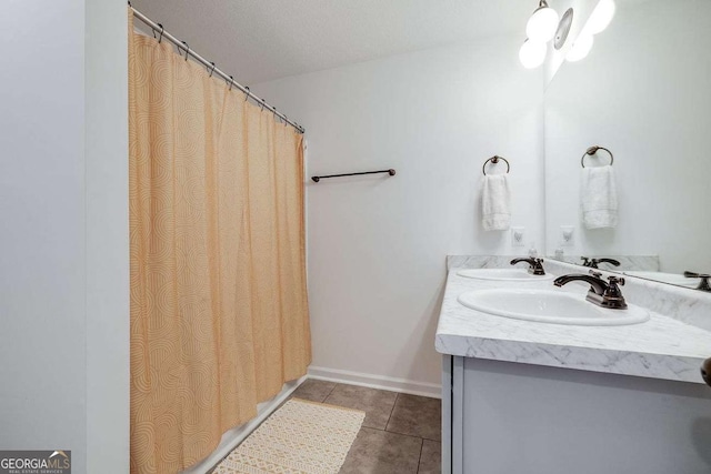 bathroom with tile patterned flooring and double vanity