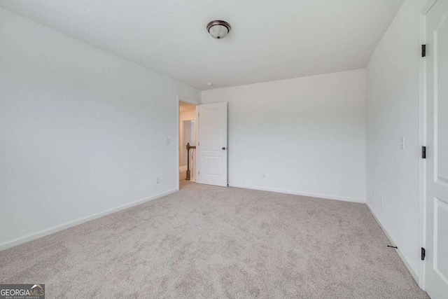 unfurnished bedroom with carpet and baseboards