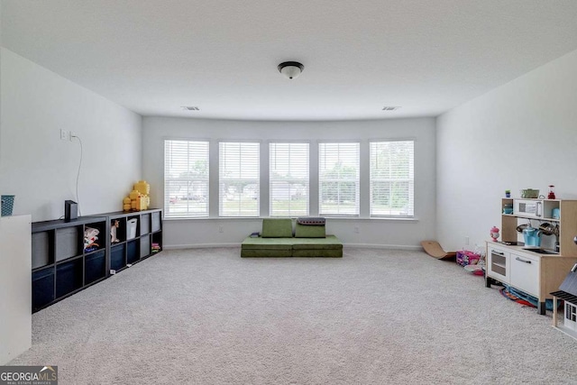 rec room with carpet and baseboards
