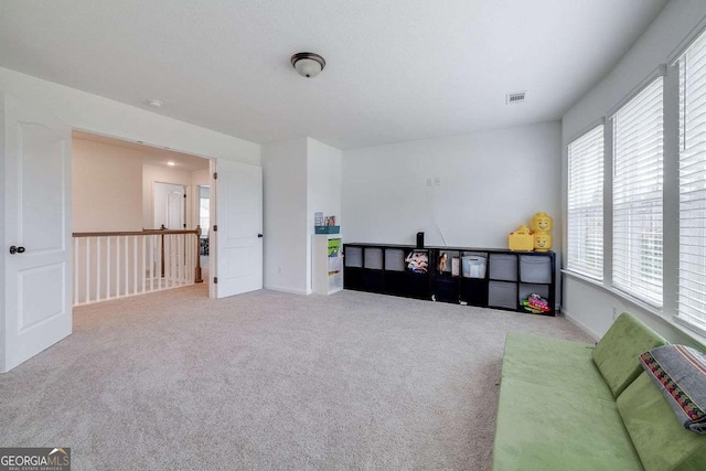 sitting room with carpet and baseboards