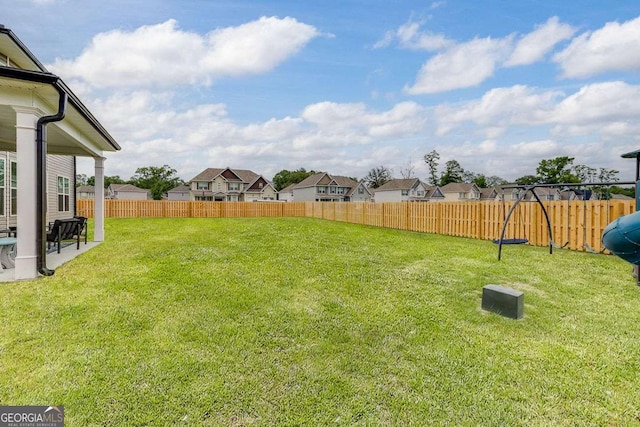 view of yard featuring a residential view, a playground, and a patio