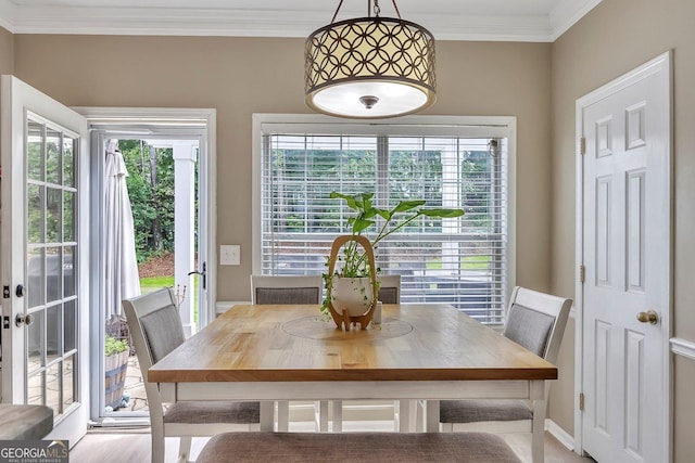 dining area featuring crown molding and baseboards