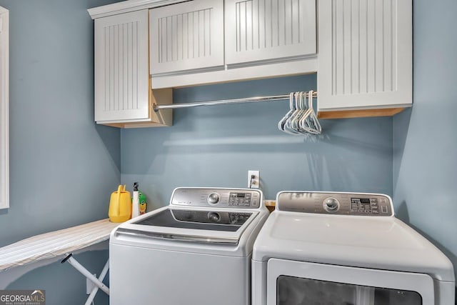 laundry area with washer and dryer and cabinet space