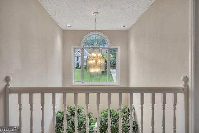 detailed view of a textured ceiling, a chandelier, and recessed lighting