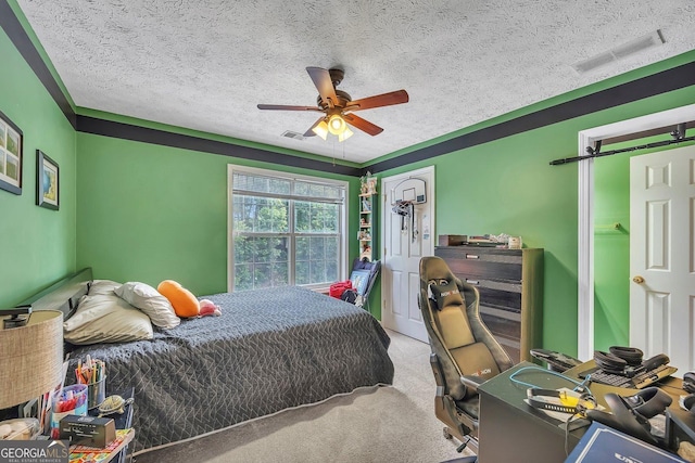 bedroom with carpet flooring, a textured ceiling, and ceiling fan