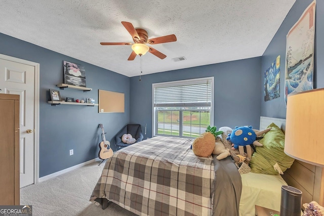 bedroom featuring carpet flooring, a textured ceiling, baseboards, and a ceiling fan