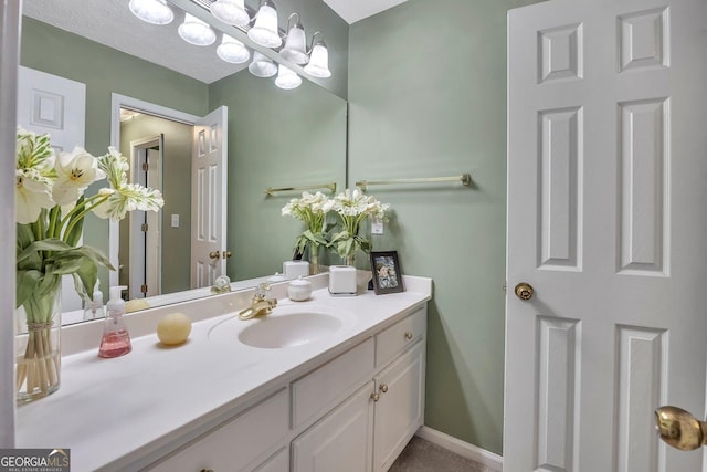 bathroom featuring vanity and baseboards
