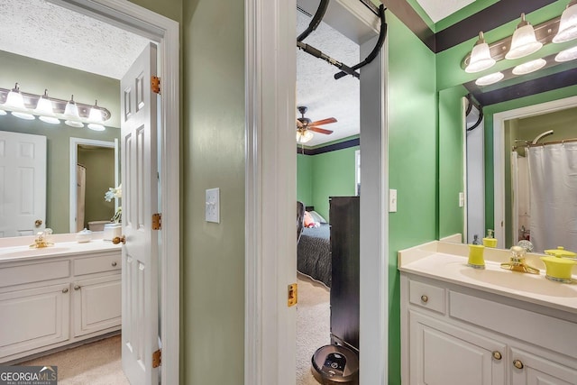 full bathroom with a textured ceiling, vanity, and a ceiling fan