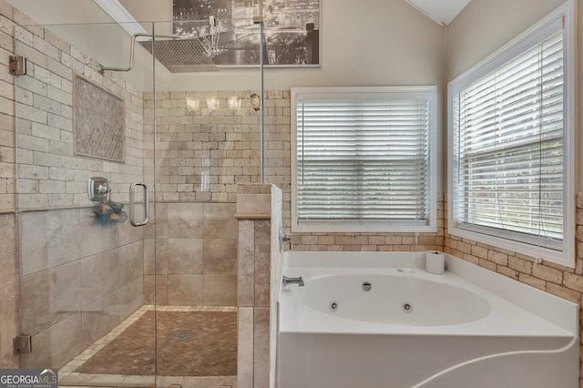 bathroom with a jetted tub and a shower stall