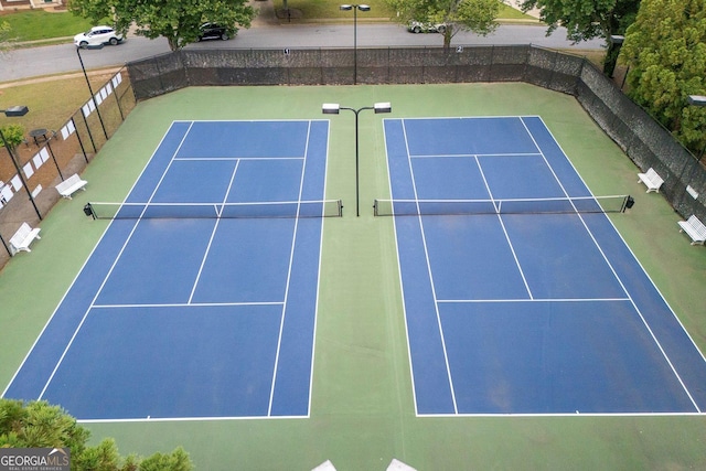 view of tennis court with fence and community basketball court