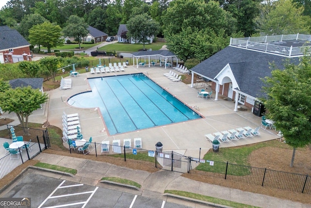 community pool with fence, central AC unit, and a patio area