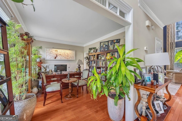 sitting room featuring wood finished floors, an office area, and crown molding