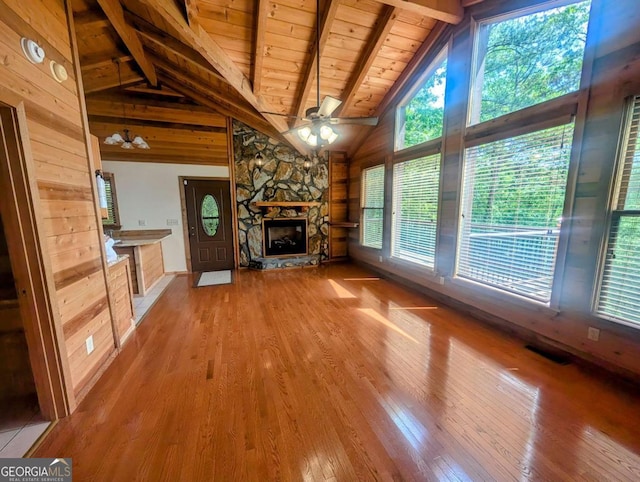 350 Left Turn Unit 15, Blue Ridge, GA 30513 - unfurnished living room with wood ceiling, wood finished floors, ceiling fan, beamed ceiling, and a stone fireplace