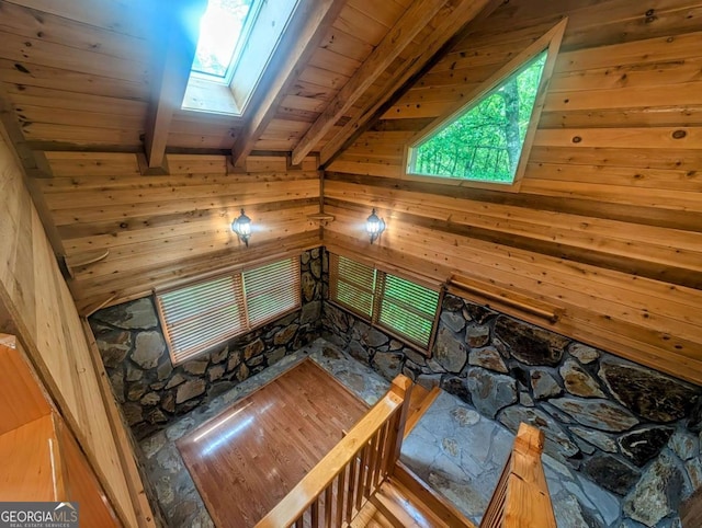 350 Left Turn Unit 15, Blue Ridge, GA 30513 - unfurnished living room with a skylight, beamed ceiling, wooden ceiling, and wood walls