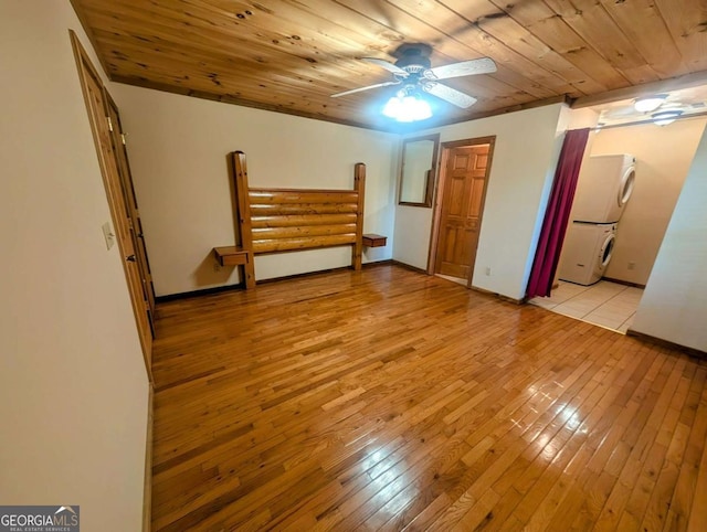 350 Left Turn Unit 15, Blue Ridge, GA 30513 - unfurnished bedroom featuring stacked washing machine and dryer, light wood-style floors, baseboards, wood ceiling, and ceiling fan