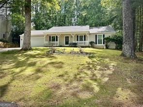 ranch-style home featuring a front yard and covered porch