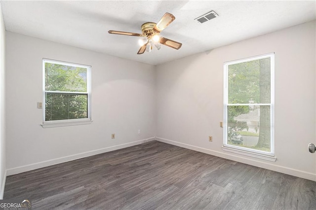 empty room with wood finished floors, baseboards, and ceiling fan