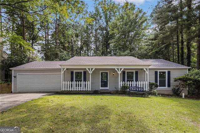 ranch-style house with a porch, an attached garage, concrete driveway, a front lawn, and roof with shingles