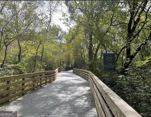 view of community with a wooded view and a deck