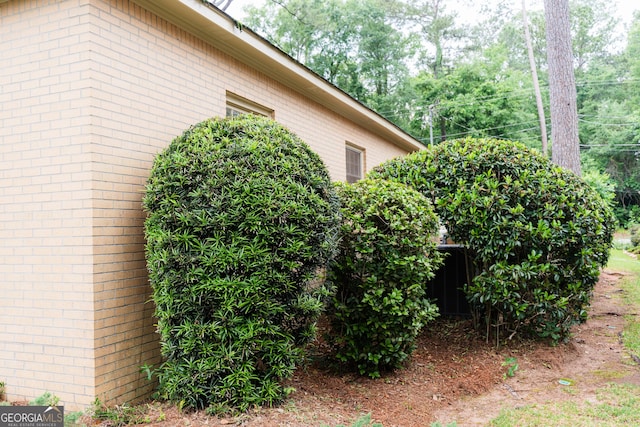 view of side of property featuring brick siding