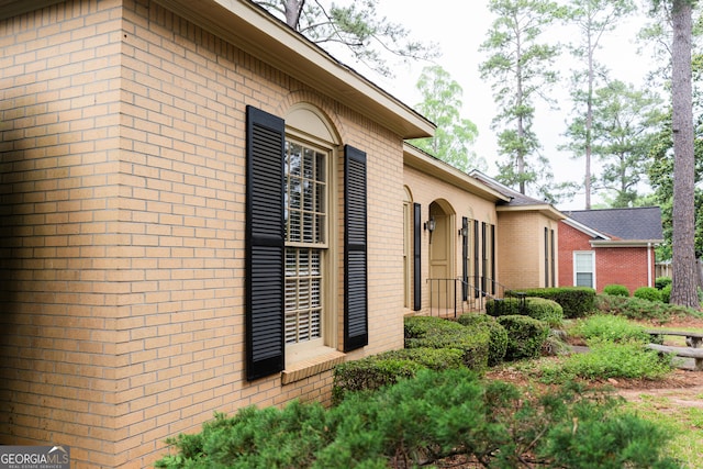 view of property exterior with brick siding