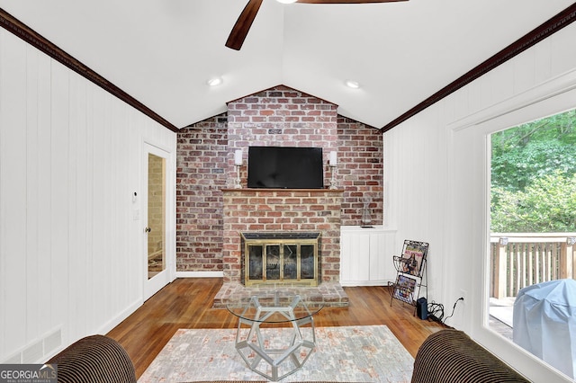 1981 Bramblewood Dr NE, Atlanta, GA 30329 - living area with a ceiling fan, crown molding, wood finished floors, vaulted ceiling, and a brick fireplace