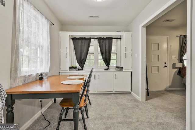 office space featuring light colored carpet and baseboards