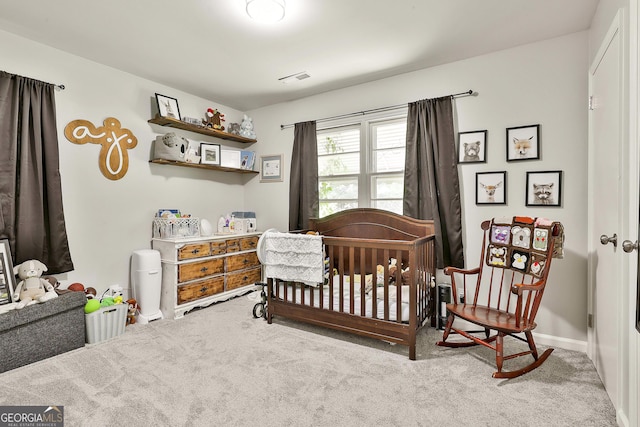 bedroom featuring carpet flooring, a nursery area, and baseboards