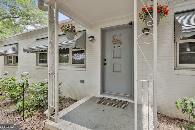 entrance to property with brick siding