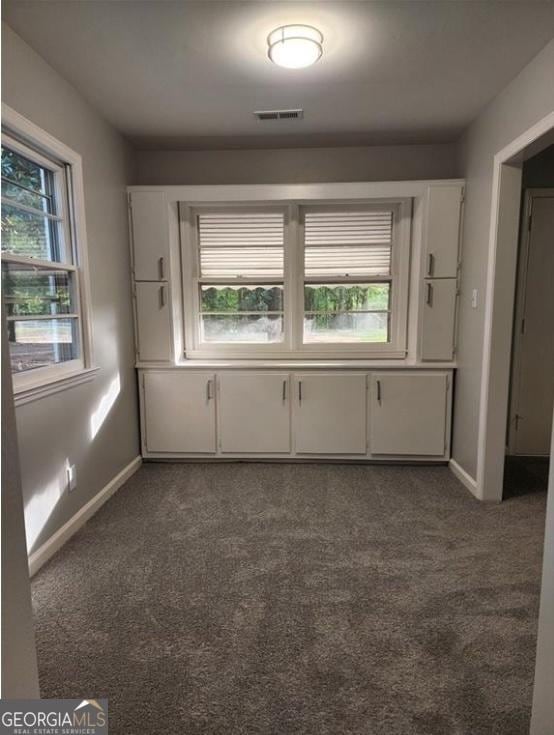 carpeted spare room with baseboards