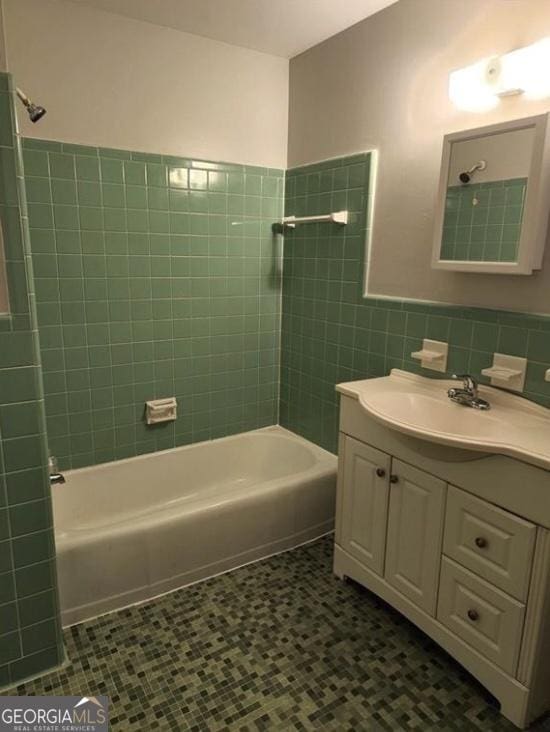 bathroom with shower / washtub combination, tile walls, vanity, and tile patterned floors