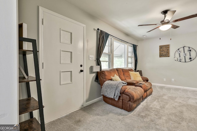 living area with a ceiling fan, carpet floors, and baseboards