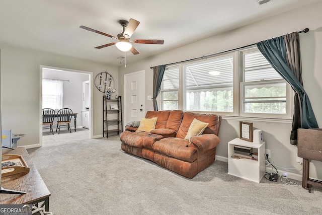 living room with a ceiling fan, carpet flooring, and baseboards