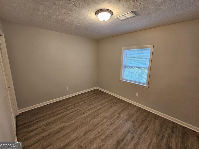 2860 Cocklebur Cove Ct, Decatur, GA 30034 - unfurnished room with dark wood-style flooring, baseboards, and a textured ceiling
