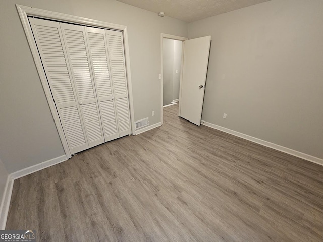 2860 Cocklebur Cove Ct, Decatur, GA 30034 - unfurnished bedroom featuring wood finished floors, baseboards, and a closet