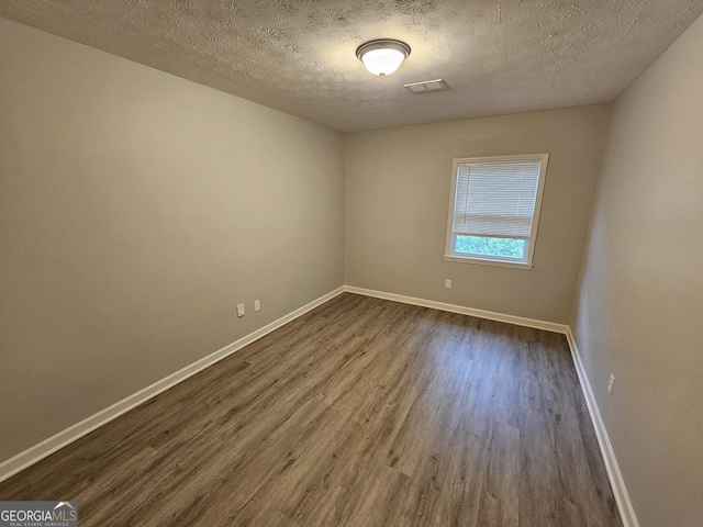 2860 Cocklebur Cove Ct, Decatur, GA 30034 - spare room with dark wood finished floors, baseboards, and a textured ceiling