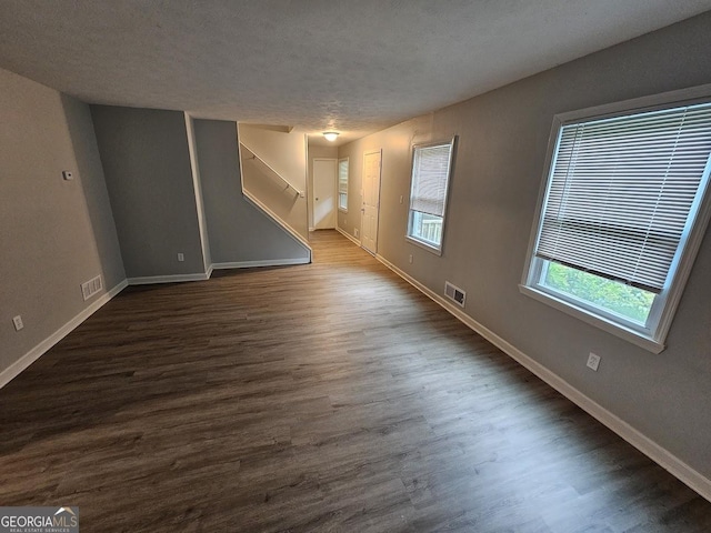 2860 Cocklebur Cove Ct, Decatur, GA 30034 - unfurnished living room with dark wood finished floors, baseboards, and a textured ceiling