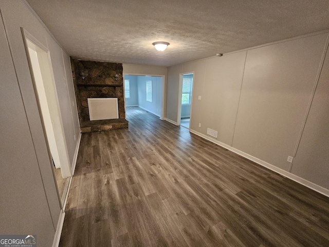 2860 Cocklebur Cove Ct, Decatur, GA 30034 - unfurnished living room with a textured ceiling, dark wood-style floors, a fireplace, and baseboards