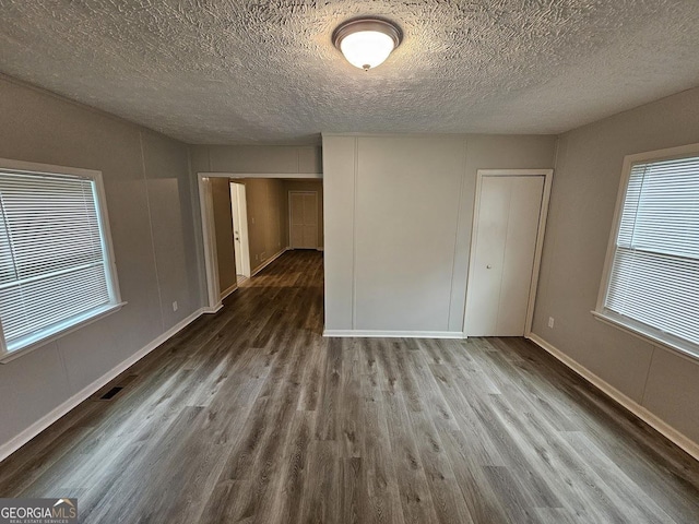 2860 Cocklebur Cove Ct, Decatur, GA 30034 - empty room with wood finished floors, a textured ceiling, plenty of natural light, and baseboards