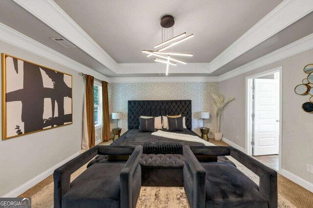 139 Coldwater Ln, Griffin, GA 30224 - carpeted bedroom featuring a tray ceiling, a chandelier, and ornamental molding