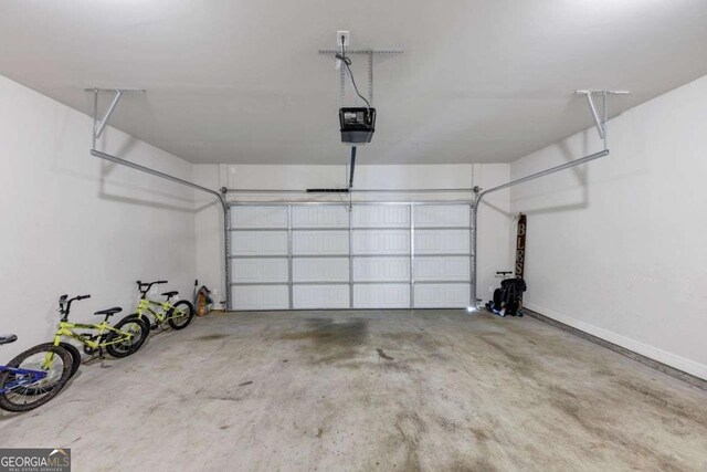 139 Coldwater Ln, Griffin, GA 30224 - garage featuring a garage door opener and baseboards