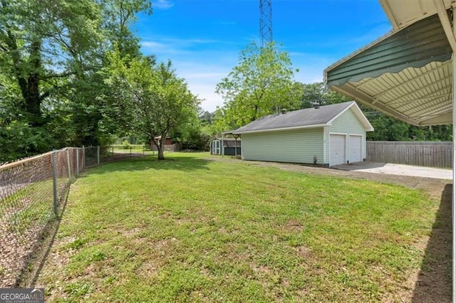view of yard featuring an outbuilding and a garage