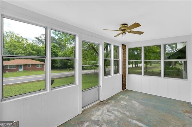 unfurnished sunroom with ceiling fan
