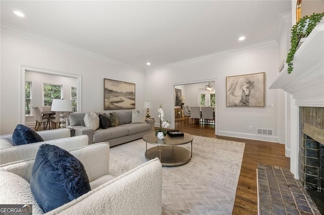 1260 Heards Ferry Rd, Sandy Springs, GA 30328 - living area with plenty of natural light, ornamental molding, wood finished floors, a tiled fireplace, and recessed lighting