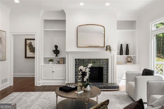1260 Heards Ferry Rd, Sandy Springs, GA 30328 - living area with built in shelves, wood finished floors, ornamental molding, recessed lighting, and a tiled fireplace