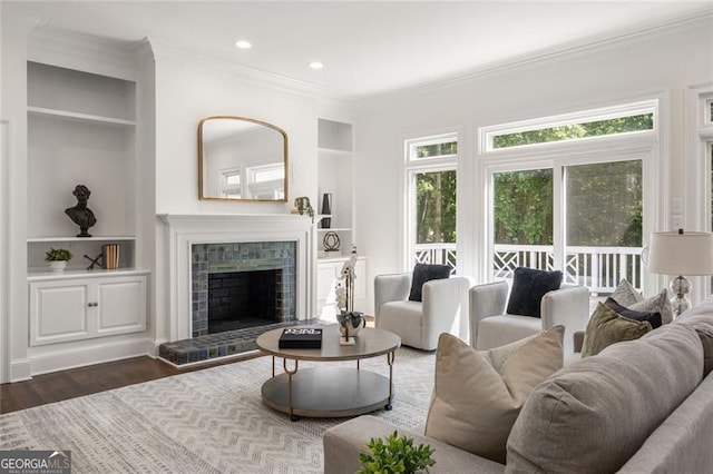 1260 Heards Ferry Rd, Sandy Springs, GA 30328 - living room with ornamental molding, wood finished floors, built in shelves, a fireplace, and recessed lighting