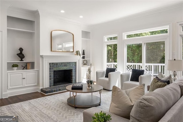 1260 Heards Ferry Rd, Sandy Springs, GA 30328 - living room with ornamental molding, wood finished floors, a brick fireplace, built in features, and recessed lighting