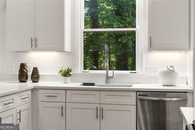 1260 Heards Ferry Rd, Sandy Springs, GA 30328 - kitchen with stainless steel dishwasher, a sink, light countertops, and white cabinetry