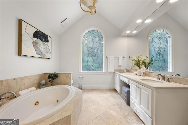 1260 Heards Ferry Rd, Sandy Springs, GA 30328 - bathroom with vaulted ceiling, a whirlpool tub, plenty of natural light, double vanity, and tile patterned floors
